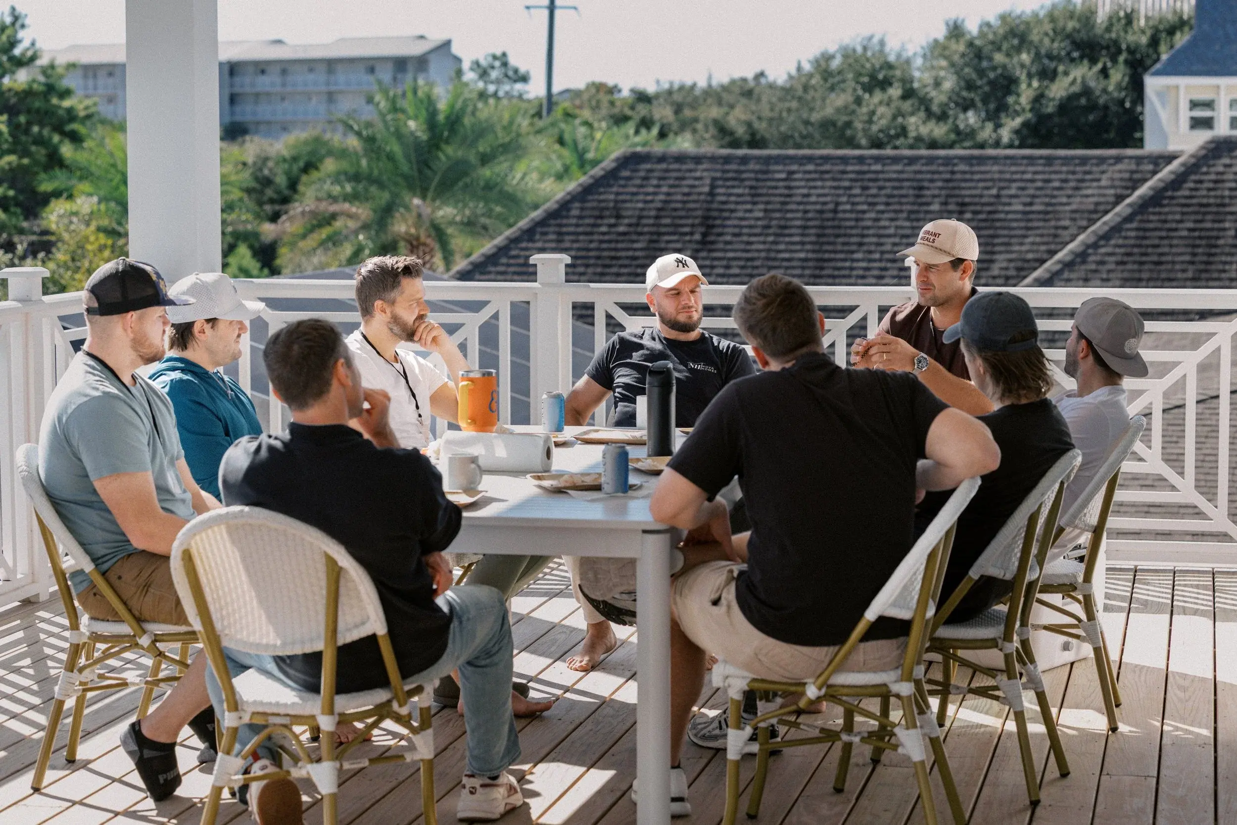 Members gathered around a long table on a deck