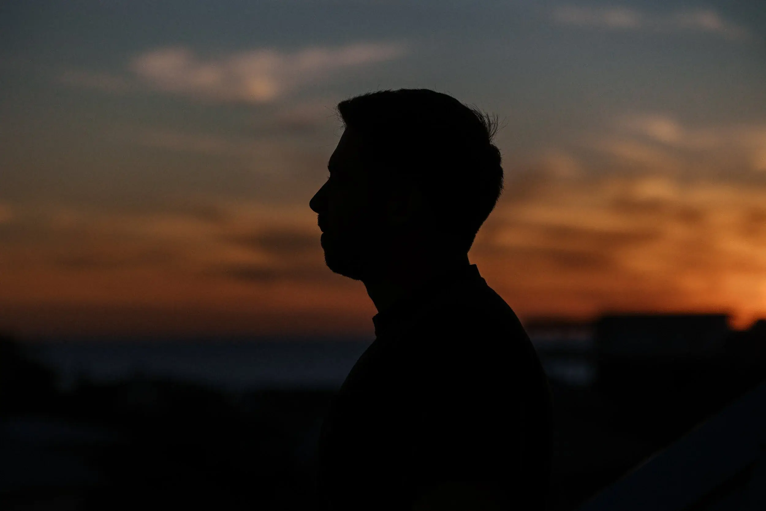 A member in silhouette against the sunset